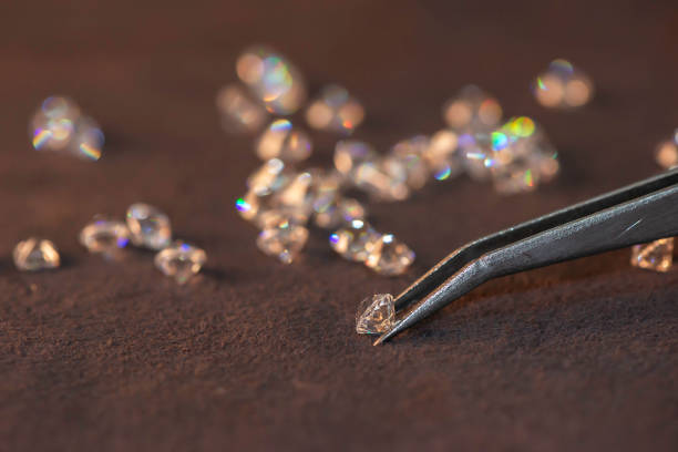 istock Diamonds of different cuts and sizes on light background with shadows. 1924188209