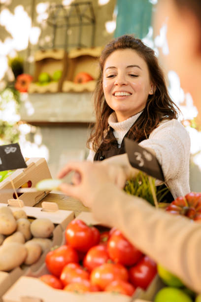 istock Shop owner gives customer fresh apple 1924228858