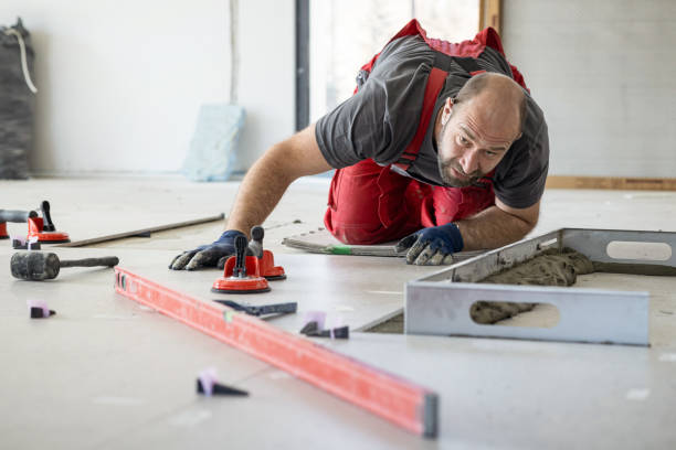 istock Man kneeing and levelling tiles 1924230687