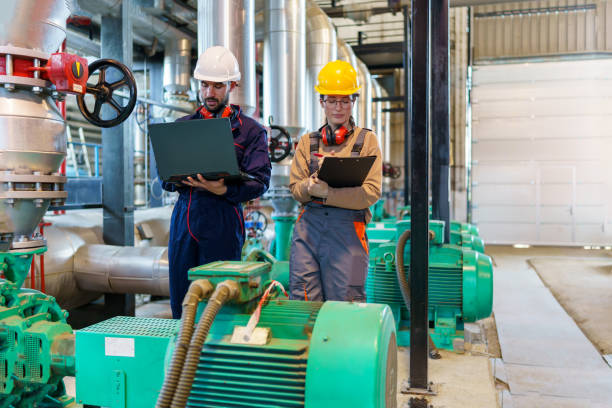 istock Professionals stay up to date with technology using laptops in heating plant 1924235547