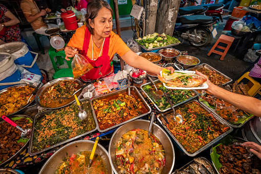 Thai street food seller at the night market in Chiang Mai, Northern Thailand