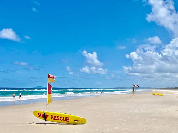 Volunteer surf lifesavers of Lifesaving Australia patrol offshore in an inflatable motorboat off Bondi Beach, Sydney. In the foreground are people enjoying the surf as waves crash close to shore.  This image was taken from the southern end of the beach on a hot and sunny afternoon on 29 December 2024.