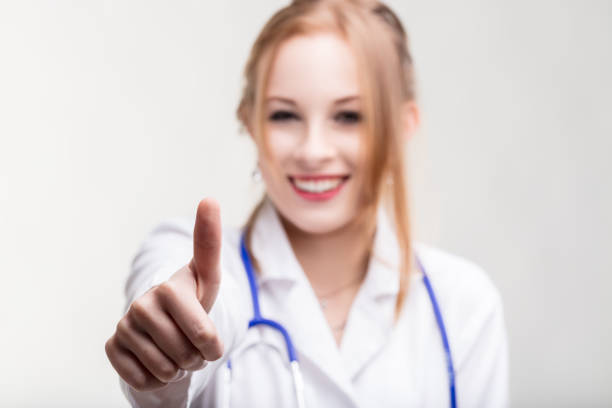 Healthcare worker in white coat exudes positivity, offering a reassuring thumbs-up
