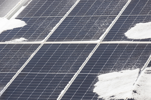 Solar power station panels with snow in winter.