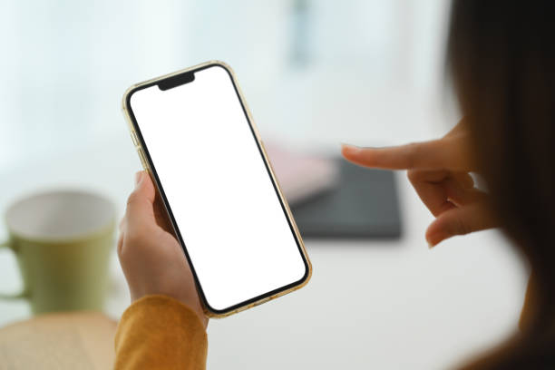 istock Closeup woman hands holding mobile phone with empty screen for advertising or message 1924254130
