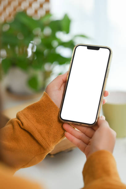 istock Closeup woman hands holding mobile phone with empty screen for advertising or message 1924254132