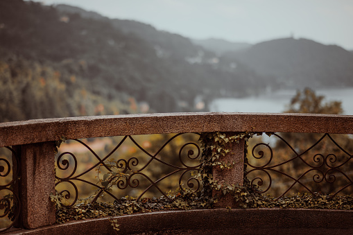 Old and beautiful stone balcony overlooking Orta lake and mountains, Autumn - Piedmont, Italy