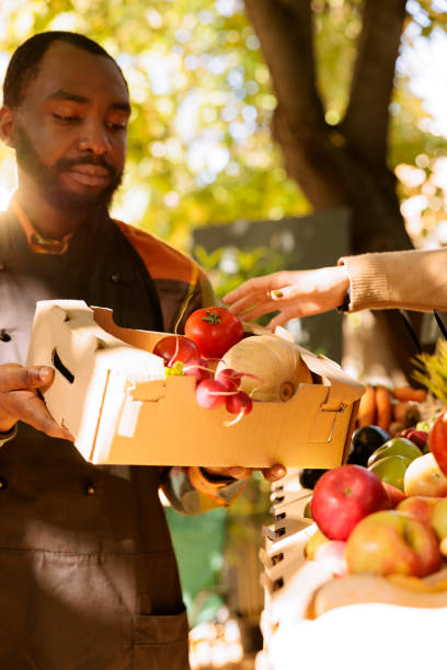 istock Black man displays fresh food products 1924280398