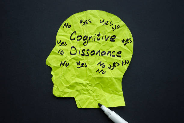 istock Paper head and handwritten inscription Cognitive dissonance. 1924332363
