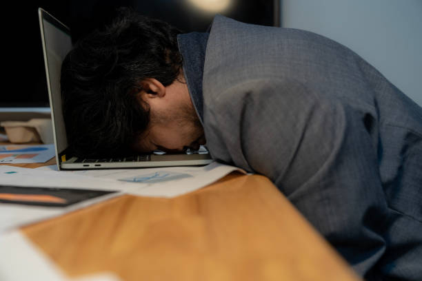 istock businessman sleeping at desk, Work hard late. 1924354359