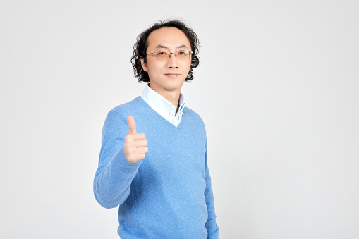 Thumbs up man in front of white background