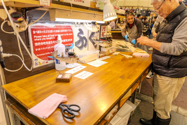 2023-11-11 Osaka, Japan. Japanese man preparing blowfish at a market stall