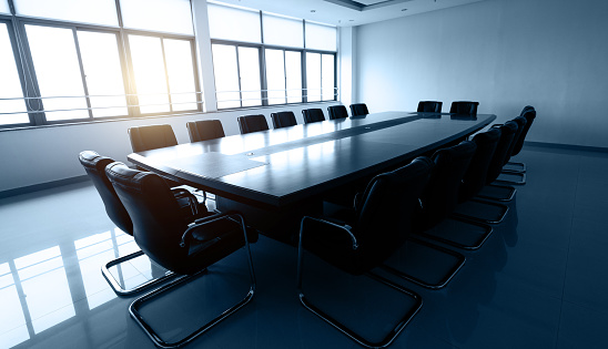 Conference table and chairs in empty meeting room