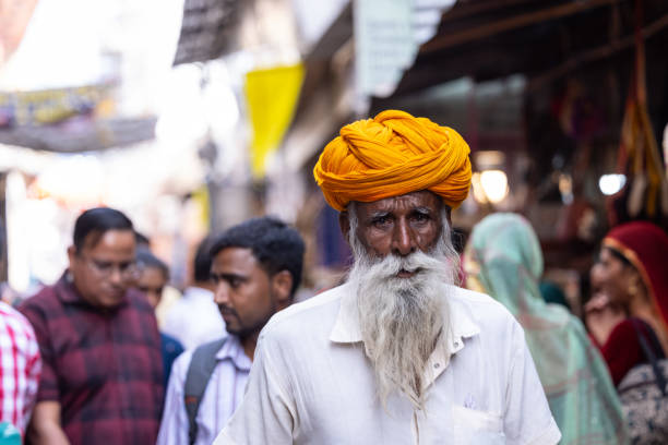 Pushkar, Rajasthan, India - November 2022: Pushkar Fair, Portrait of an old sadhu baba on the street of Pushkar during camel fair in traditional dress.