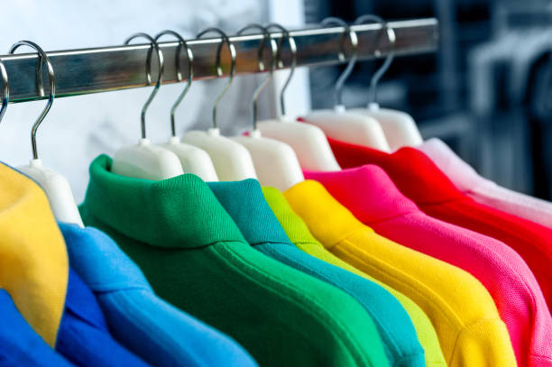 colorful polo shirts on hangers in a row - polo shirt multi colored clothing variation стоковые фото и изображения