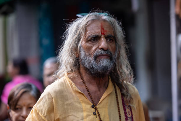 Pushkar, Rajasthan, India - November 2022: Pushkar Fair, Portrait of an old sadhu baba on the street of Pushkar during camel fair in traditional dress.