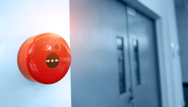 istock Manual push station of fire alarm system, installed on the wall near the fire exit door 1924377152