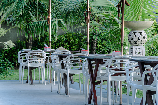 many wooden chairs and tables were arranged neatly