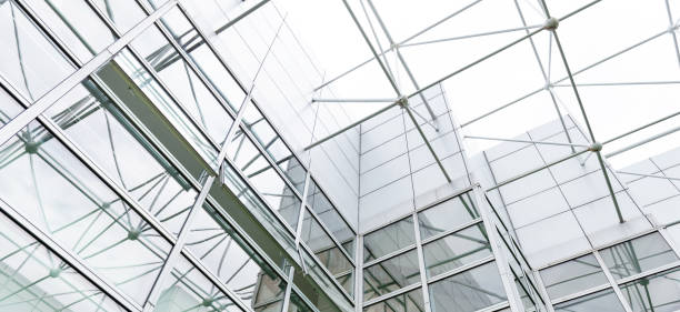 istock Low angle view of modern glass office building interior 1924379335
