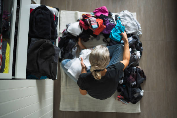 istock top view woman sorting clothings in dressing room 1924386327