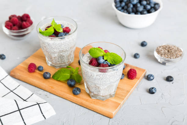 istock Healthy breakfast or morning with chia seeds vanilla pudding raspberry and blueberry berries on table background, vegetarian food, diet and health concept. Chia pudding with raspberry and blueberry 1924387432