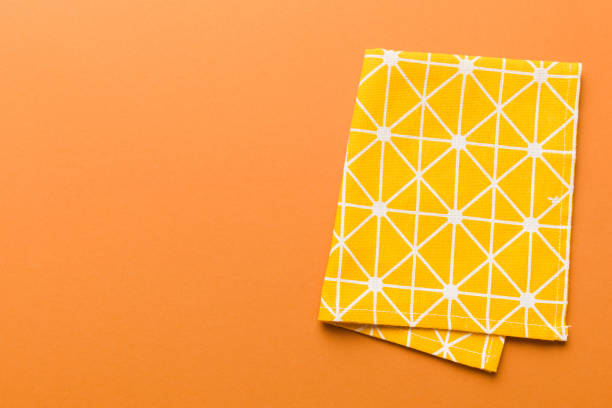 istock top view with yellow empty kitchen napkin isolated on table background. Folded cloth for mockup with copy space, Flat lay. Minimal style 1924387446