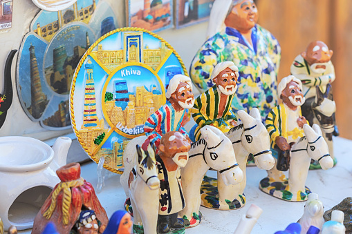 Colorful painted clay figurines of Nasreddin Hodja (Afandi) on his donkey. Traditional souvenir from Uzbekistan