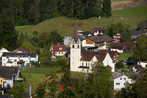 Aerial view of the village of Ennetmoos in Nidwalden in Switzerland, with the Catholic Church of St. Jakob central. Copy space above.