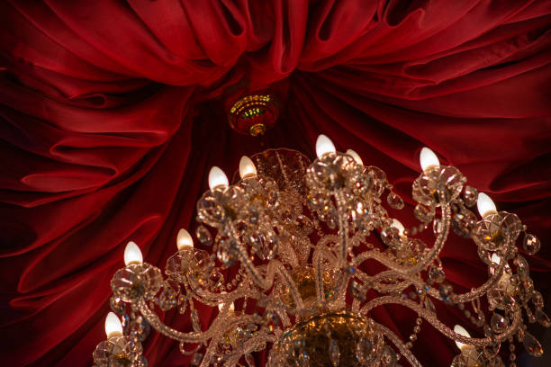 istock Bohemian crystal chandelier with red satin fabric ceiling drape. 1924406224