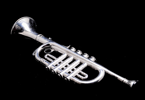 Silver Vintage Toy Trumpet on a Black Background