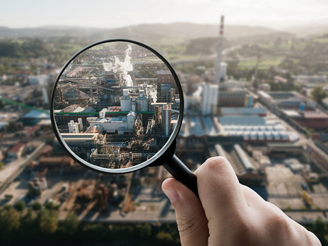 A magnifying glass focusing on industrial buildings