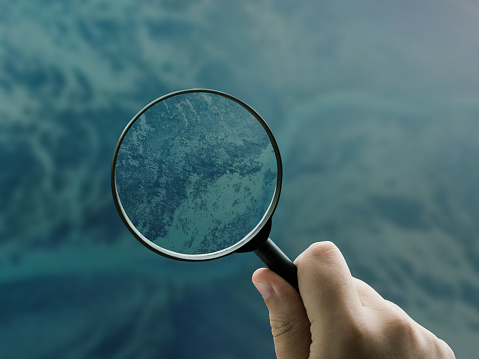 A magnifying glass focusing on the seabed
