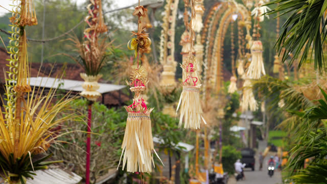 Decorated element hanging from penjor pole, slow motion shot