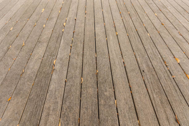 A wooden bakcground with some leaves on it