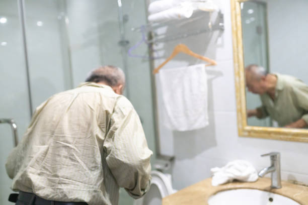 old man washing teeth in the bathroom
