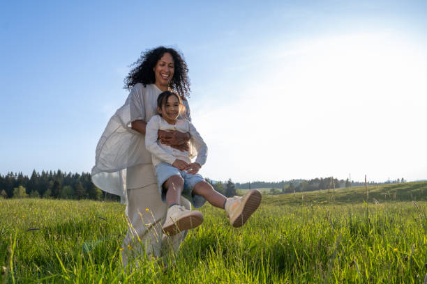 istock Woman spinning her daughter in meadow 1924430997