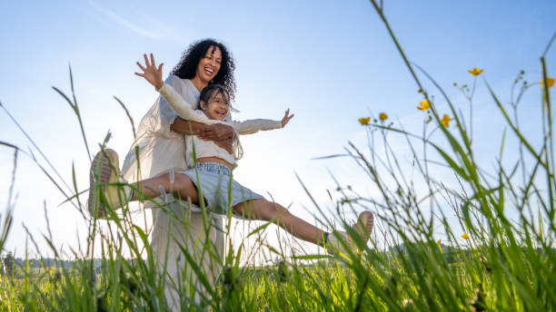 istock Woman spinning her daughter in meadow 1924431002