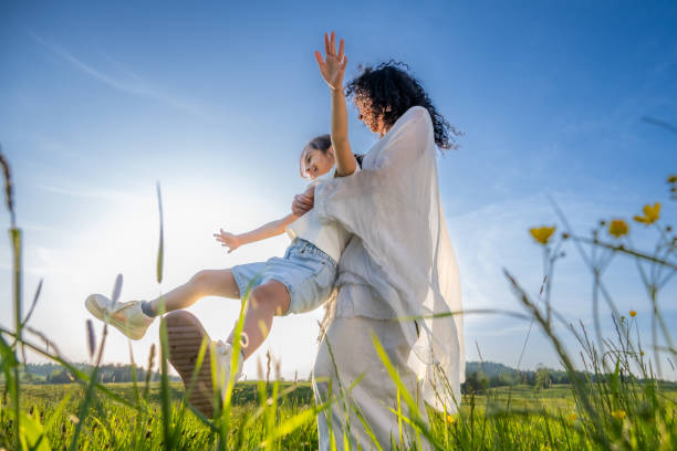istock Woman spinning her daughter in meadow 1924431025