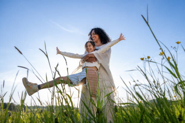 istock Woman spinning her daughter in meadow 1924431035