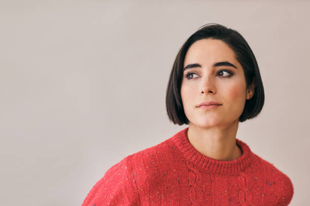 istock woman thinking looking away at copy space wearing a red sweater 1924431594