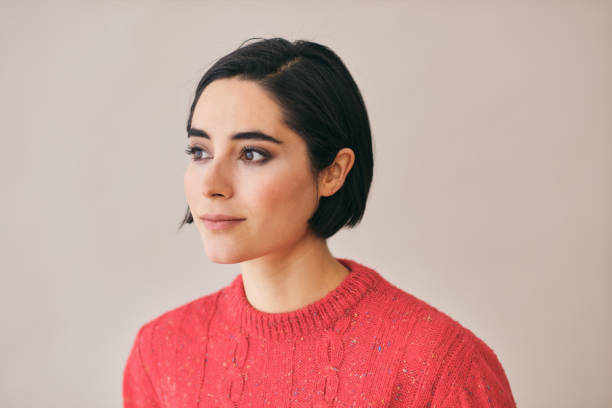 woman thinking looking away at copy space wearing a red sweater