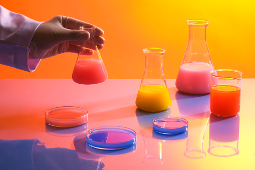 Colorful chemical liquid are divided into several different laboratory glassware. Research and develop beauty skincare product concept by scientific method with concept laboratory tests