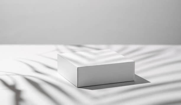 istock Empty podium for product. Minimal white box on a light background with shadows. 1924462367
