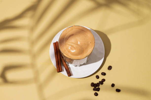 istock Dalgona coffee. Whipped instant coffee in a glass on a saucer with cinnamon sticks 1924463981
