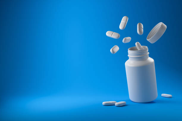 White pills and plastic medical container on a blue background. White pills and plastic medical container on a blue background. Medicine and health concept. 3d rendering. antiviral drug stock pictures, royalty-free photos & images