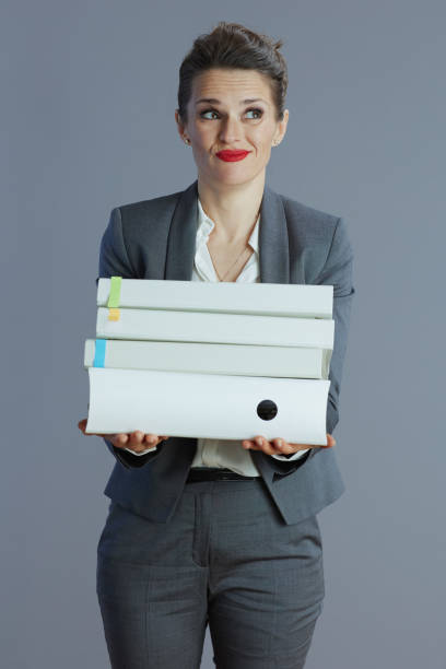 istock stressed modern female employee against grey background 1924503906