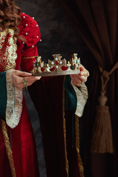 istock Closeup on medieval queen in red dress with crown 1924520749