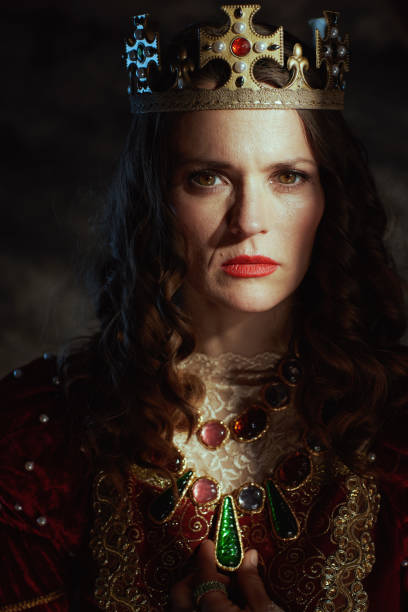 istock medieval queen in red dress with crown 1924520754