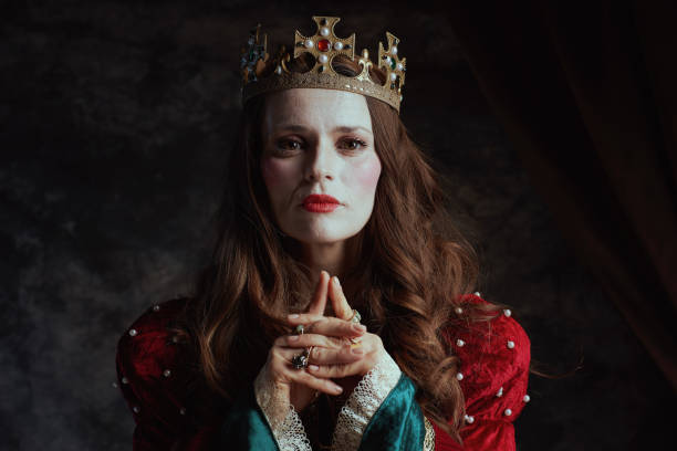 istock medieval queen in red dress with white makeup and crown 1924520763