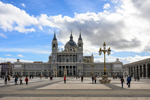 Madrid, Spain - Oct 28, 2023: Almudena Cathedral, or Catedral de la Almudena, under cloudy sky.
